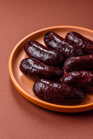 Blood sausage, pudding, meat food with lard and spices. Blood sausage cooked on the grill for dinnerの写真素材