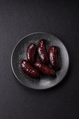 Blood sausage, pudding, meat food with lard and spices. Blood sausage cooked on the grill for dinnerの写真素材