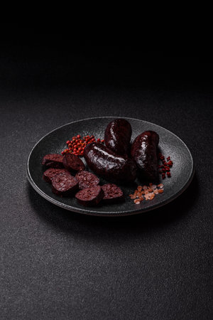 Blood sausage, pudding, meat food with lard and spices. Blood sausage cooked on the grill for dinnerの写真素材