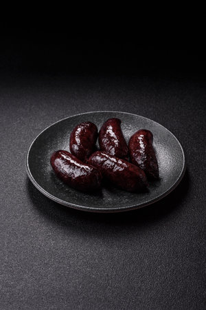 Blood sausage, pudding, meat food with lard and spices. Blood sausage cooked on the grill for dinnerの写真素材