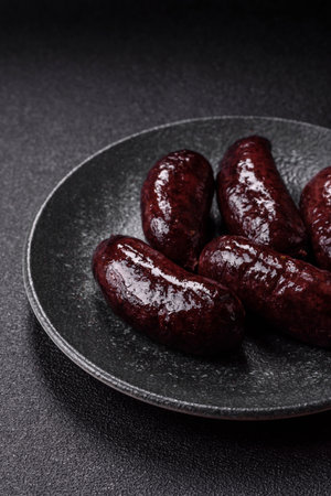 Blood sausage, pudding, meat food with lard and spices. Blood sausage cooked on the grill for dinnerの写真素材