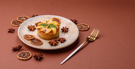Sweet round pie or tart with apples and peach, cream and nuts.