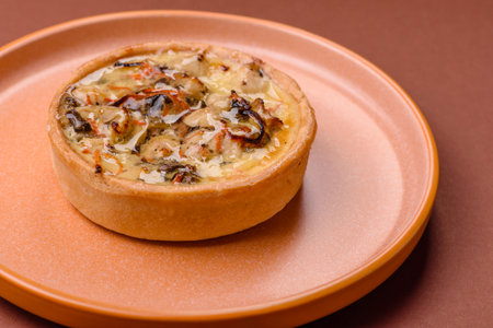 Pie or quiche, a sour tart with chicken and mushrooms, spices and herbs on a dark concrete background. Round quiche with chickenの写真素材