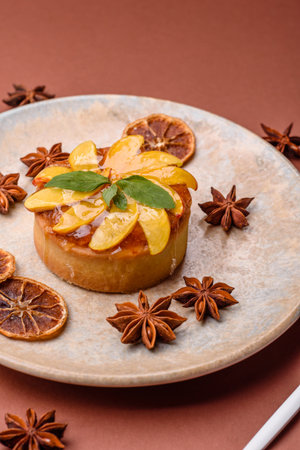 Sweet round pie or tart with apples and peach, cream and nuts. Mini sweet tart with fruit slicesの写真素材