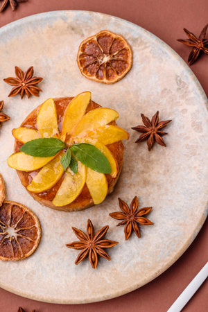 Sweet round pie or tart with apples and peach, cream and nuts. Mini sweet tart with fruit slicesの写真素材