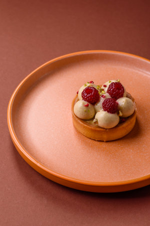 Sweet cake or tart round with cream and raspberries. Raspberry sweet tart for birthdays or weddings
