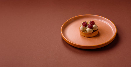 Sweet cake or tart round with cream and raspberries. Raspberry sweet tart for birthdays or weddings