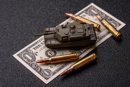 Money, cash dollars to fund weapons for war and defense against attack. Dollars for war as a conceptual backdropの写真素材