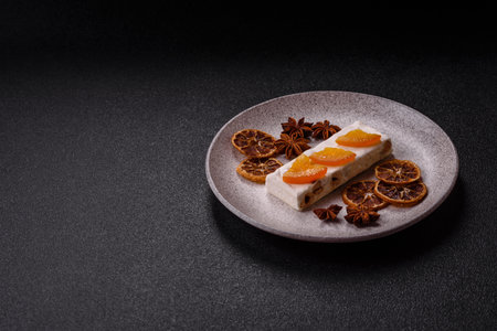 Nougat or white caramel with hazelnuts and pistachios and citrus pieces. White nougat with nuts,...