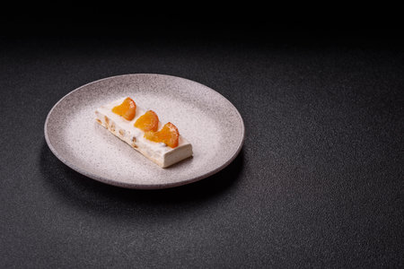 Nougat or white caramel with hazelnuts and pistachios and citrus pieces. White nougat with nuts,...