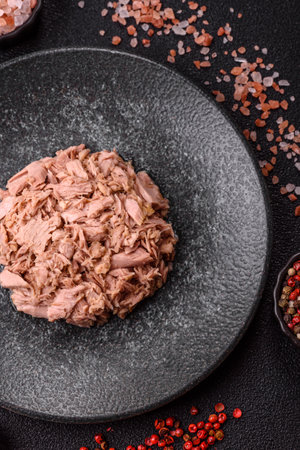 Tuna, canned fish in a can and on a plate for making sandwiches and other food. Canned tuna as an ingredient for cooking healthy foodの写真素材