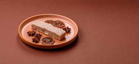 Nougat or white caramel with hazelnuts and pistachios and citrus pieces. White nougat with nuts,...