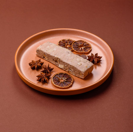 Nougat or white caramel with hazelnuts and pistachios and citrus pieces. White nougat with nuts,...