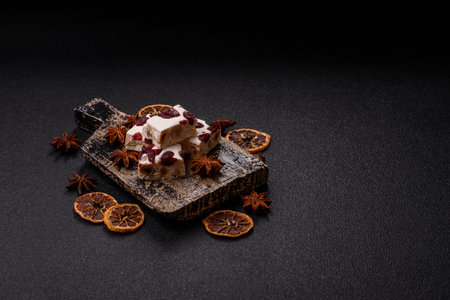 Nougat or white caramel with hazelnuts and pistachios and citrus pieces. White nougat with nuts, sweets for the festive tableの写真素材