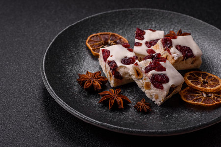Nougat or white caramel with hazelnuts and pistachios and citrus pieces. White nougat with nuts,...