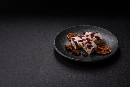 Nougat or white caramel with hazelnuts and pistachios and citrus pieces. White nougat with nuts, sweets for the festive tableの写真素材