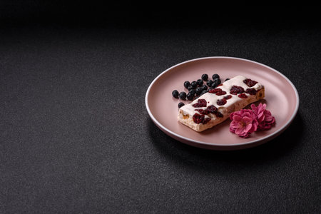 Nougat or white caramel with hazelnuts and pistachios and citrus pieces. White nougat with nuts,...
