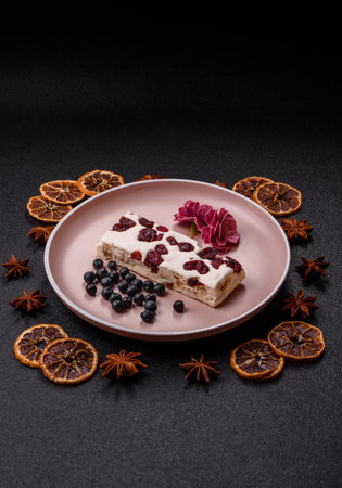 Nougat or white caramel with hazelnuts and pistachios and citrus pieces. White nougat with nuts, sweets for the festive tableの写真素材