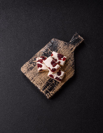 Nougat or white caramel with hazelnuts and pistachios and citrus pieces. White nougat with nuts, sweets for the festive tableの写真素材