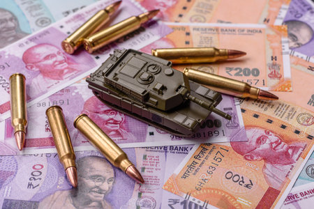 Money and flag of India with ammunition and tank as a concept of weapons and preparation for war....