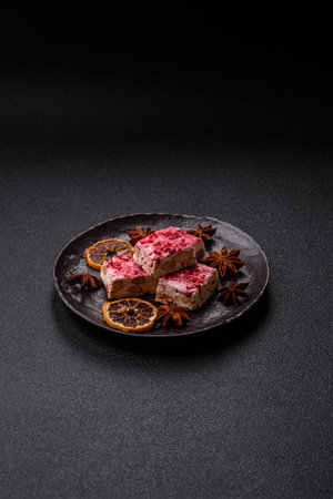 Nougat or white caramel with hazelnuts and pistachios and strawberry pieces. White nougat with nuts,...