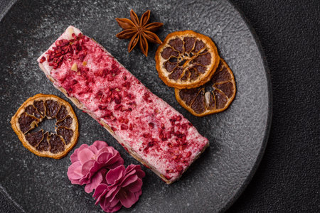 Nougat or white caramel with hazelnuts and pistachios and strawberry pieces. White nougat with nuts,...