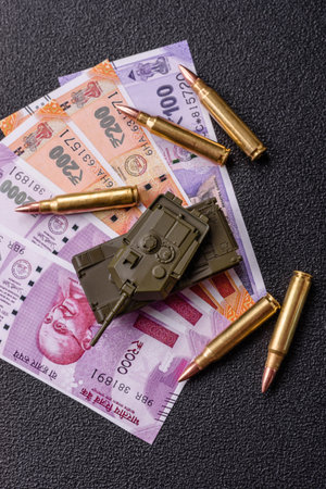 Money and flag of India with ammunition and tank as a concept of weapons and preparation for war....
