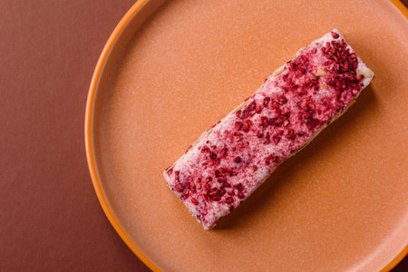 Nougat or white caramel with hazelnuts and pistachios and strawberry pieces. White nougat with nuts,...