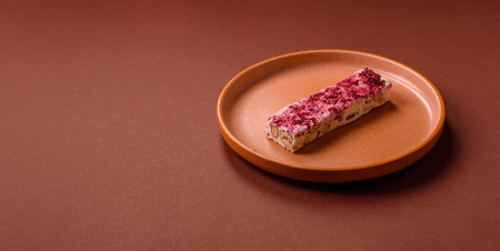 Nougat or white caramel with hazelnuts and pistachios and strawberry pieces. White nougat with nuts, sweets for the festive tableの写真素材