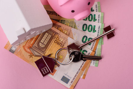 House, buying or selling real estate, concept background with money and piggy bank. Real estate, background for agency or for rentの写真素材