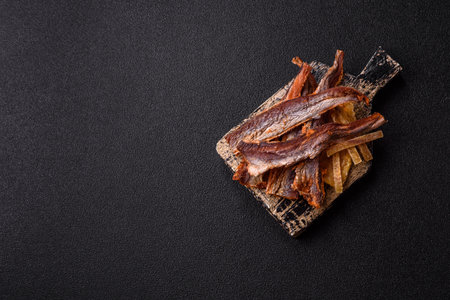 Dried salted fish as snacks or jerky, seafood as slices. Dried seafood snacks as a background for your designの写真素材