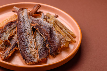Dried salted fish as snacks or jerky, seafood as slices. Dried seafood snacks as a background for your designの写真素材