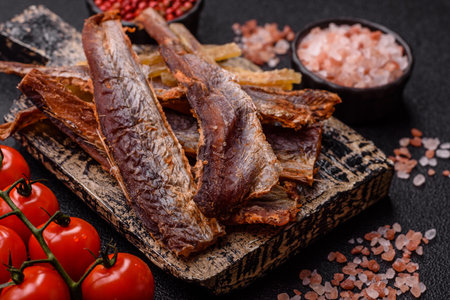 Dried salted fish as snacks or jerky, seafood as slices. Dried seafood snacks as a background for...