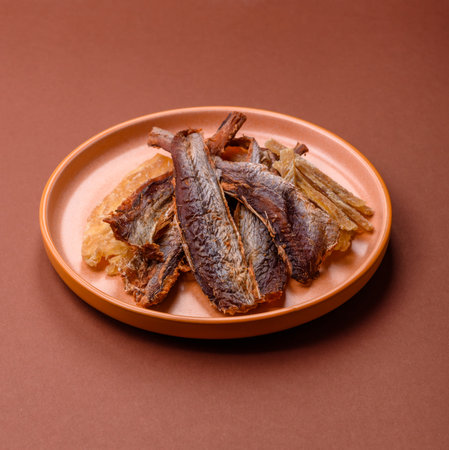 Dried salted fish as snacks or jerky, seafood as slices. Dried seafood snacks as a background for...
