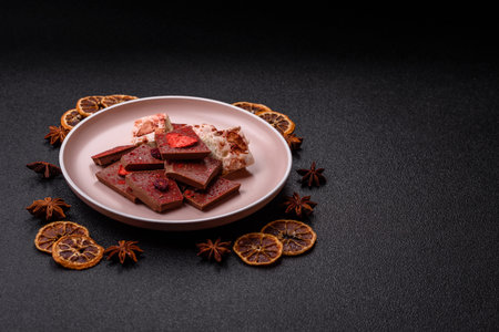 Bar sweet craft artisan chocolate with dried fruits made at home. Craft chocolate as a background...