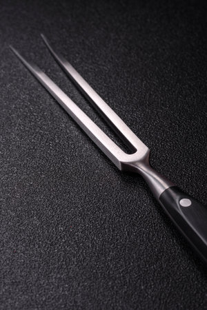 Empty meat or steak fork with vegetables, spices and other ingredients. Meat fork as a background...