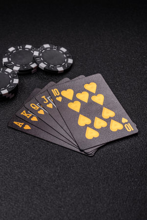 Playing card game poker in casino with chips, bets and risk. Cards and chips on green felt as...