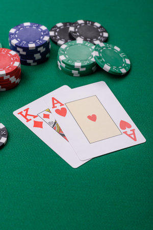 Playing blackjack or baccarat card game in casino with chips, bets and risk. Cards and chips on...