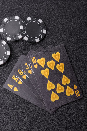Playing card game poker in casino with chips, bets and risk. Cards and chips on green felt as...