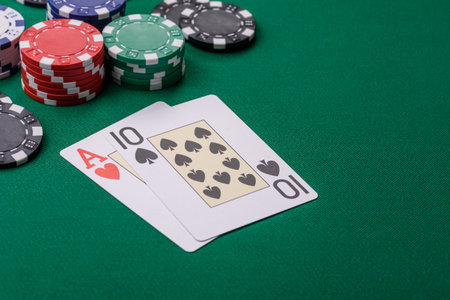 Playing blackjack or baccarat card game in casino with chips, bets and risk. Cards and chips on...