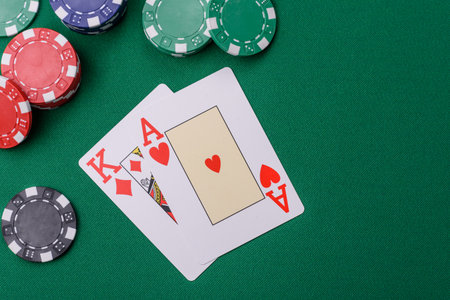Playing blackjack or baccarat card game in casino with chips, bets and risk. Cards and chips on...