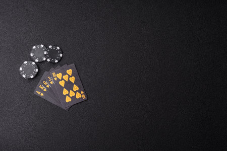 Playing card game poker in casino with chips, bets and risk. Cards and chips on green felt as...