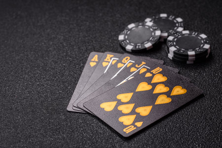 Playing card game poker in casino with chips, bets and risk. Cards and chips on green felt as...