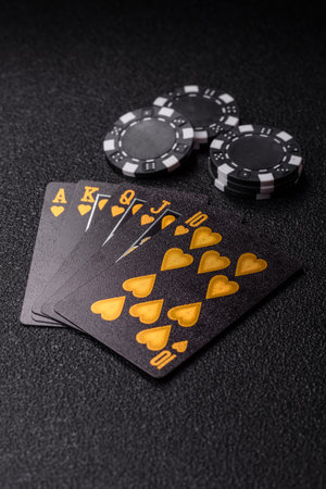 Playing card game poker in casino with chips, bets and risk. Cards and chips on green felt as...