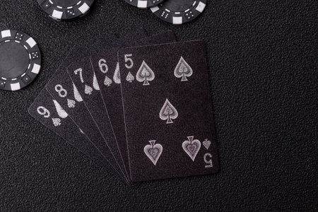 Playing card game poker with chips, bets and risk. Cards and chips on green felt as background for...