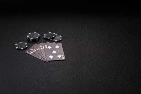 Playing card game poker with chips, bets and risk. Cards and chips on green felt as background for...