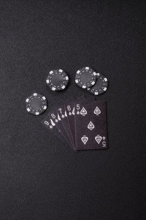 Playing card game poker in casino with chips, bets and risk. Cards and chips on green felt as...