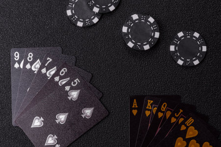 Playing card game poker in casino with chips, bets and risk. Cards and chips on green felt as...