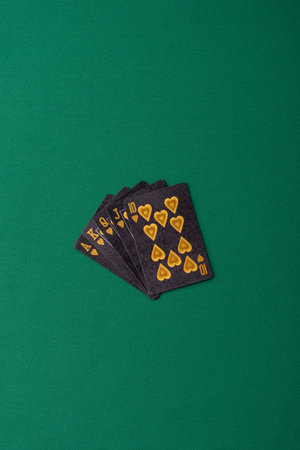 Playing card game poker with chips, bets and risk. Cards and chips on green felt as background for...