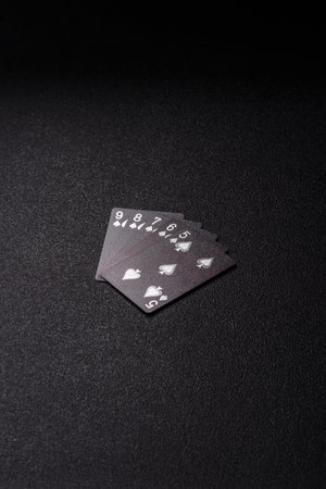 Playing card game poker with chips, bets and risk. Cards and chips on green felt as background for...